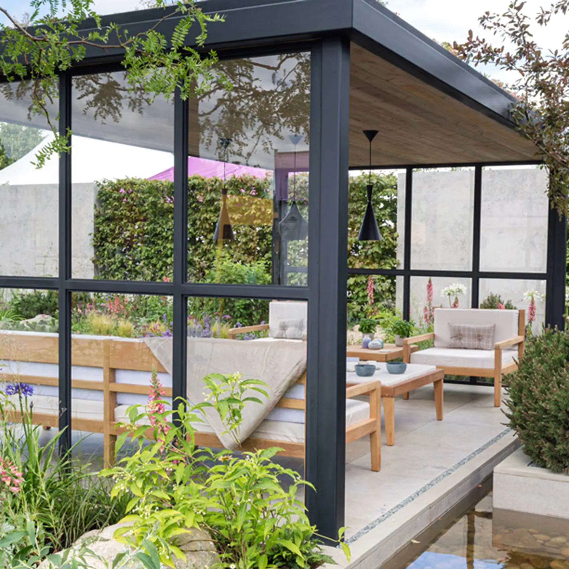 Garden pergola and furniture built by EMH Joinery at the RHS Hampton Court Flower Show.